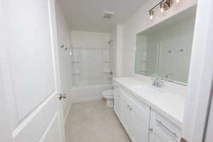 Full bath with vanity, shower / washtub combination, and light tile patterned floors