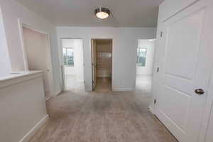 Hall with light carpet and baseboards