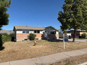 Single story home featuring brick siding