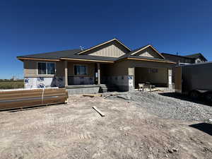 Property under construction with a garage and a shingled roof