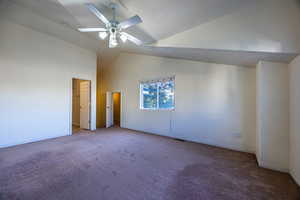 Unfurnished bedroom featuring carpet floors, high vaulted ceiling, and a ceiling fan