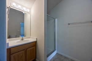 Bathroom with a stall shower, vanity, and tile patterned floors