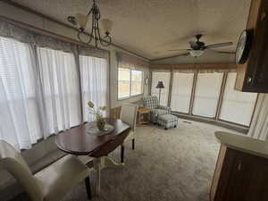 Sunroom / solarium with vaulted ceiling and a chandelier