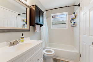 Full bathroom featuring vanity and shower / bath combination with curtain