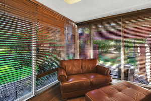 Living area with a textured ceiling and wood finished floors