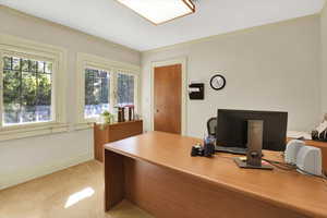 Office area featuring crown molding and light colored carpet