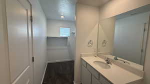 Bathroom with vanity and a textured ceiling