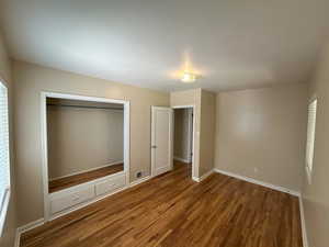 Bedroom 2 refinished hardwood, closet and entry door