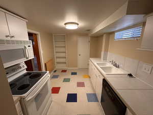 2nd Full kitchen with lots on counter space, decorative shelves, dining area and storage closet