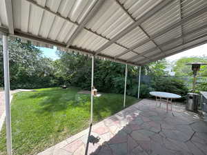 Covered patio with outdoor heater and round glass table