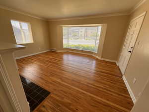 Living room featuring newly refinished hardwood floors and crown molding