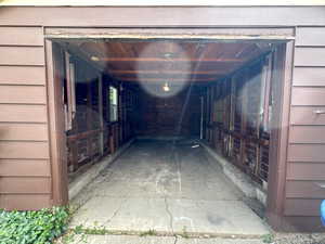 View inside garage with remote opener at the top and new window on the left