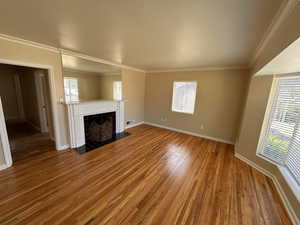 Tile gas log fireplace with clean white mantle and plenty of natural light,