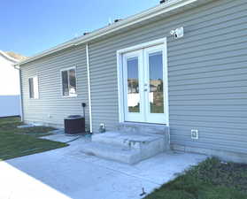 Rear view of house featuring the patio with entry steps into semi-formal dining in the kitchen, french doors.