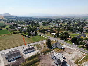 Aerial view of property's location with a mountainous background and nearby suburban area