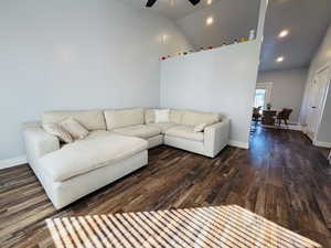 Living room with wood finished floors, high vaulted ceiling, a ceiling fan, and recessed lighting