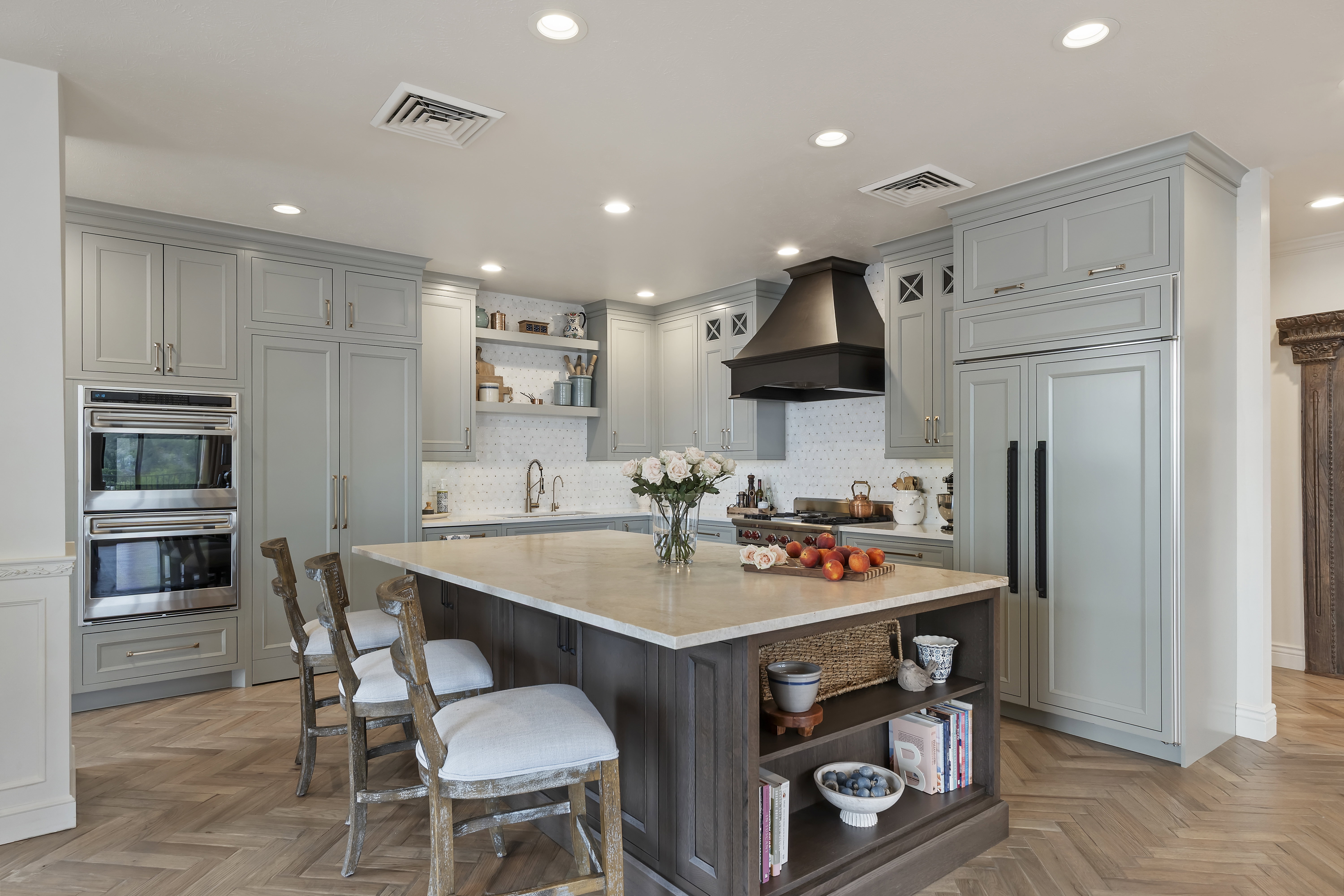 Kitchen featuring open shelves, stainless steel double oven, decorative backsplash, a kitchen bar, and custom range hood