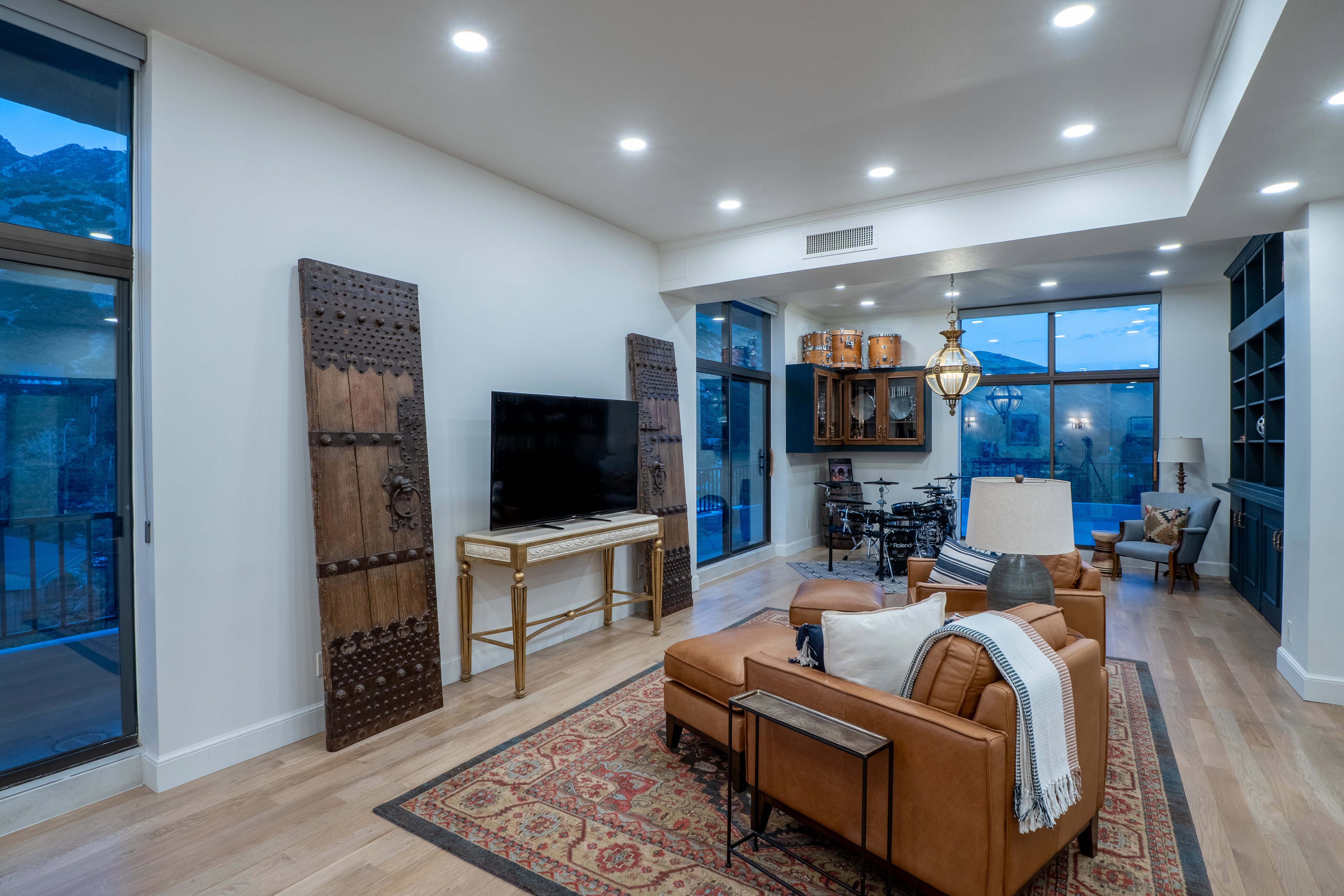 Living room featuring recessed lighting, wood finished floors, and a wall of windows