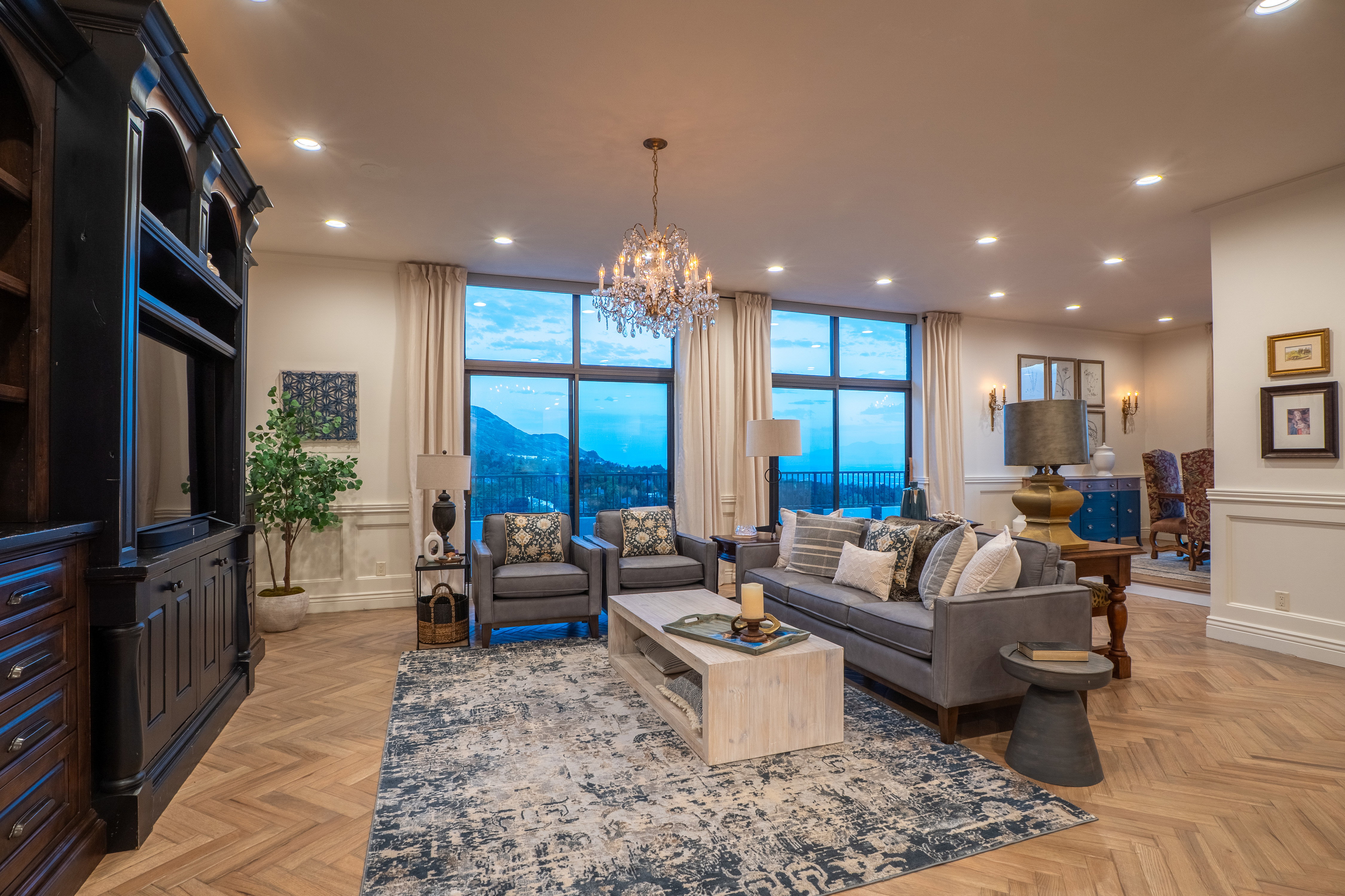 Living area with recessed lighting, a chandelier, a wainscoted wall, a mountain view, and a decorative wall