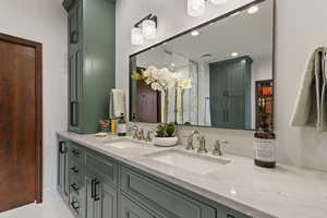 Bathroom featuring double vanity, recessed lighting, and tile patterned floors