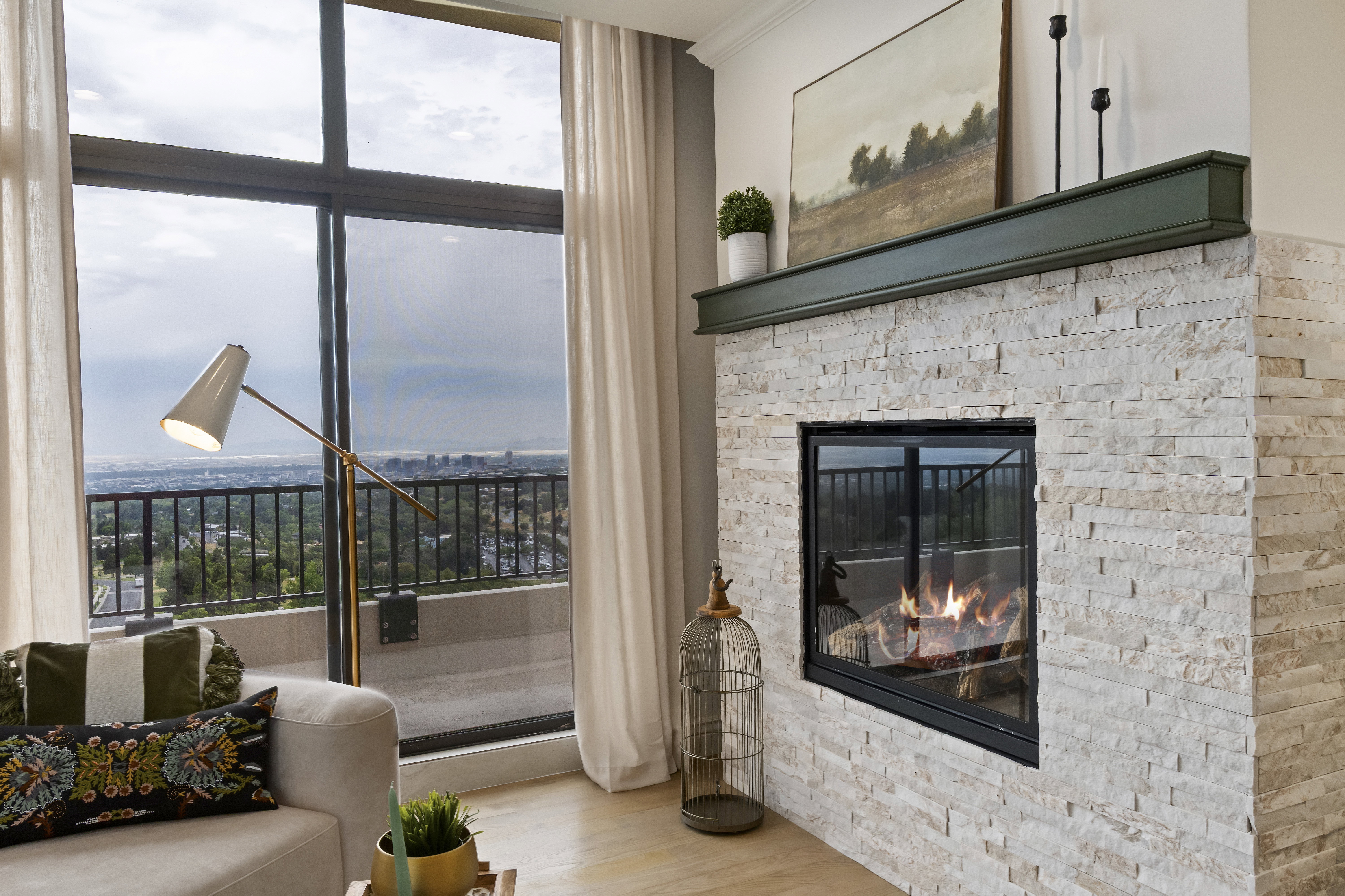 Living area featuring wood finished floors, a fireplace, and a wall of windows