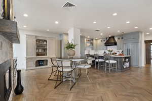 Dining area with a stone fireplace and recessed lighting