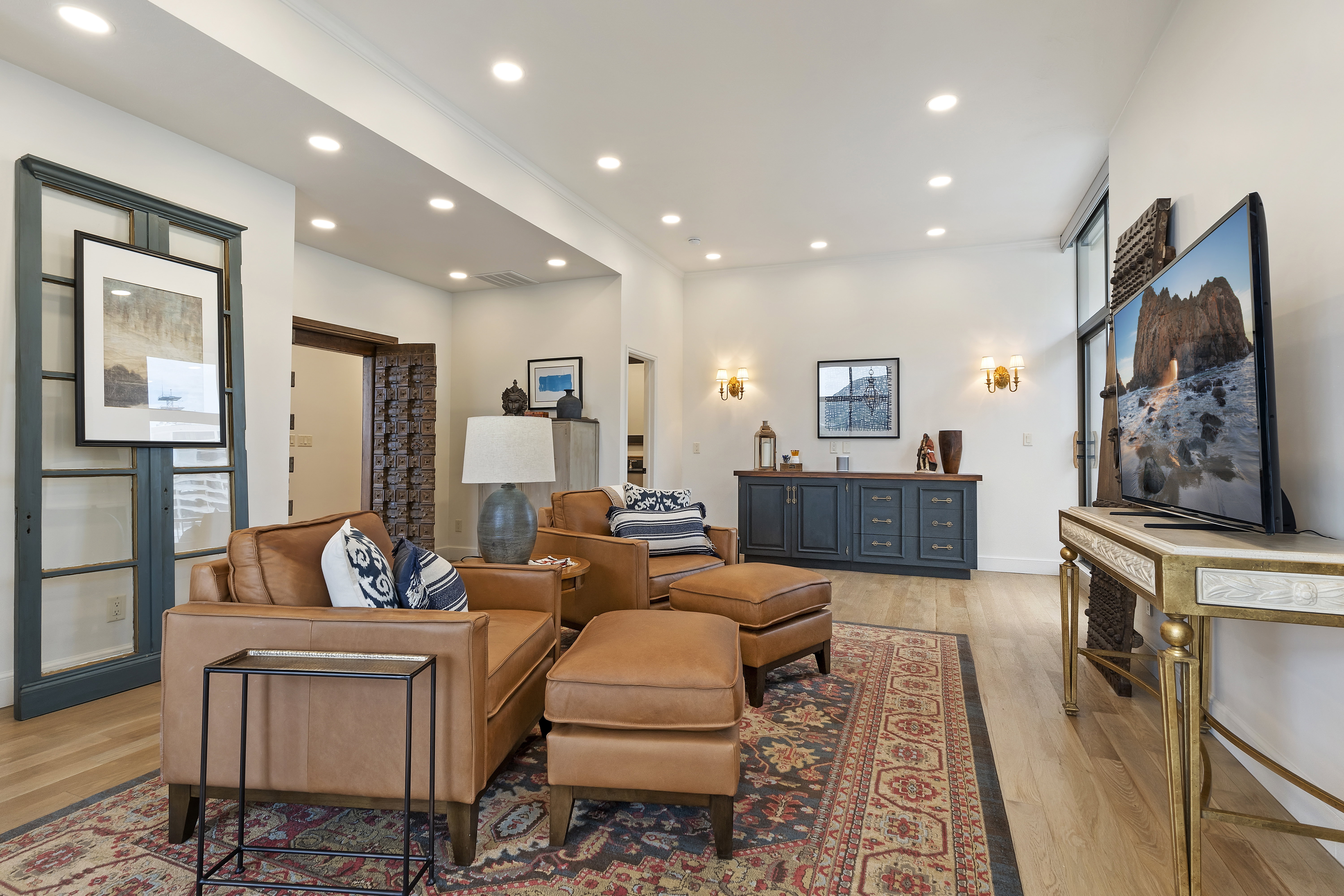Living area with light wood-style flooring and recessed lighting