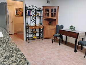 Dining area featuring light tile patterned floors and baseboards