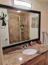 Bathroom with vanity and a shower stall