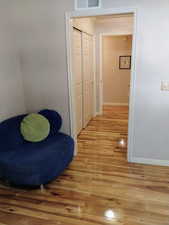Hall featuring light wood-style flooring and ornamental molding