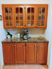 Bar with light tile patterned floors and baseboards