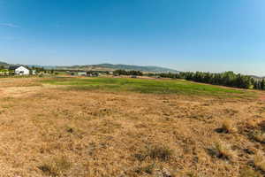 View of mountain backdrop with rural landscape