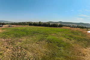 View of grassy yard with a view of countryside and a mountain view