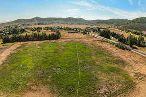 Overview of rural landscape featuring a mountainous background and property boundaries highlighted