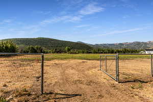 View of mountain backdrop featuring rural landscape