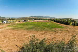 View of mountain backdrop with rural landscape