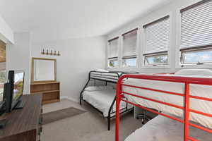 Carpeted bedroom featuring baseboards