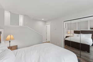 Bedroom featuring recessed lighting, a closet, and wood finished floors