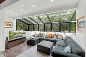 Living room featuring healthy amount of natural light, wood finished floors, and recessed lighting