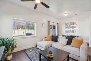 Living area with dark wood-style flooring and ceiling fan