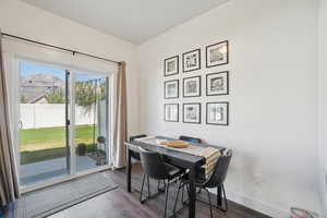 Dining room featuring dark wood finished floors and baseboards