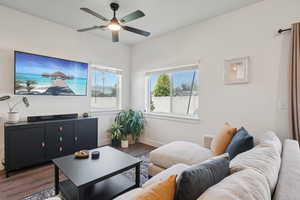 Living area with wood finished floors and a ceiling fan