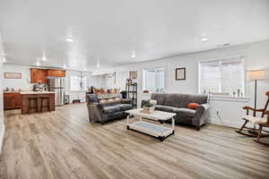 Living area featuring light wood-type flooring and recessed lighting