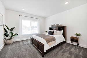 Bedroom with dark carpet and recessed lighting