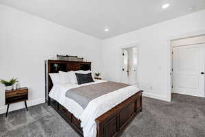 Bedroom with dark carpet and recessed lighting