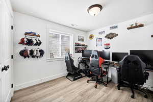 Office with light wood-style flooring and baseboards