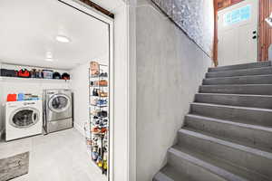 Laundry area featuring separate washer and dryer and tile patterned floors