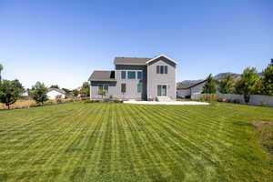 Back of house featuring a patio area and a mountain view