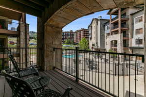 Balcony featuring view of pool