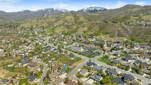 Aerial overview of property's location with a mountain backdrop and nearby suburban area